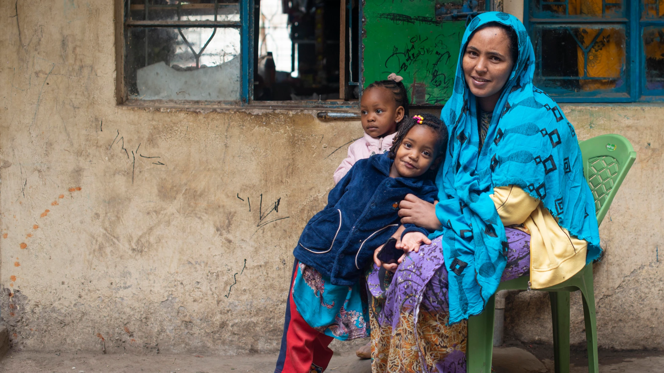 two children relaxing with woman