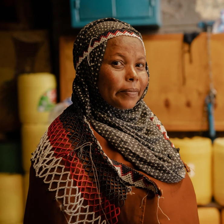 woman with a serious look in front of orange crates