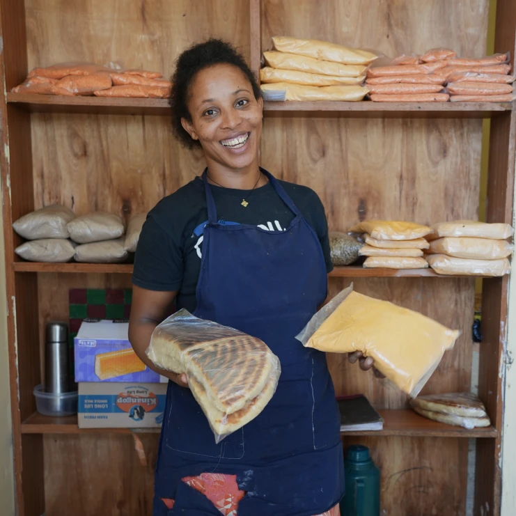 woman holding food in front of a pantry