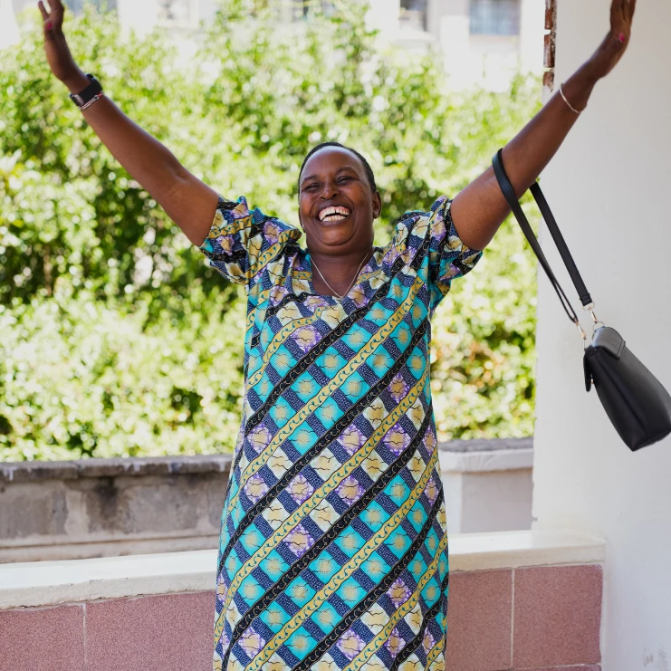 woman in a dress raising her hands