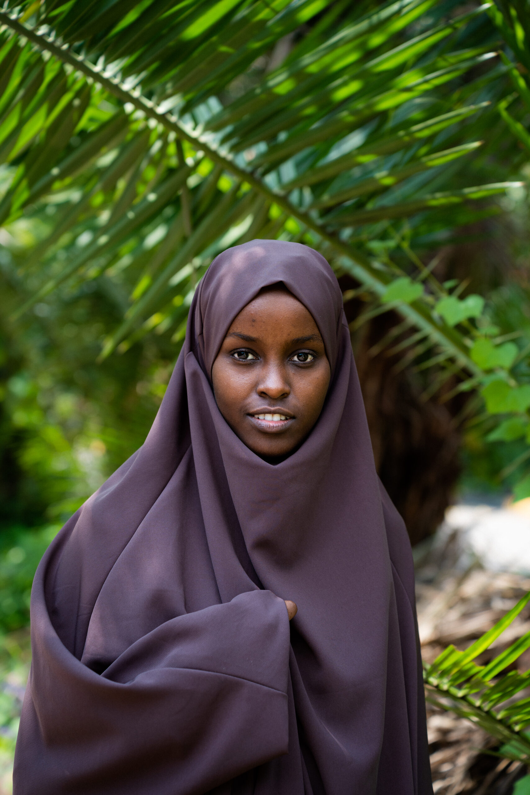 woman standing in front of greenery