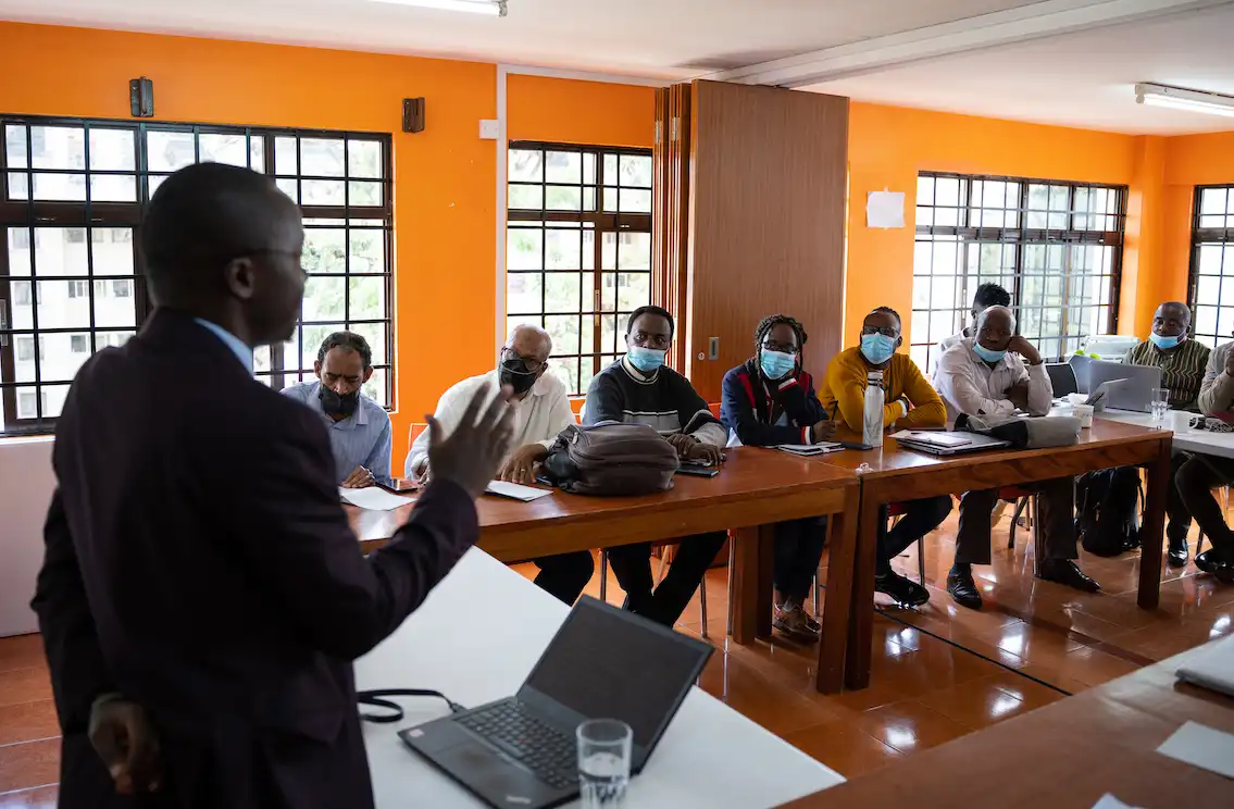 speaker addressing a group at a meeting