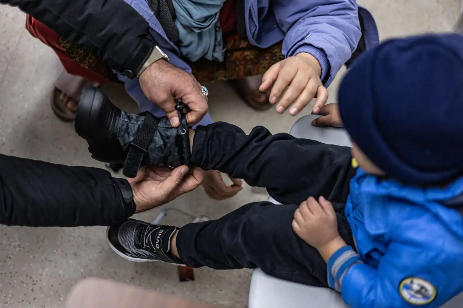 child getting help with their clothing