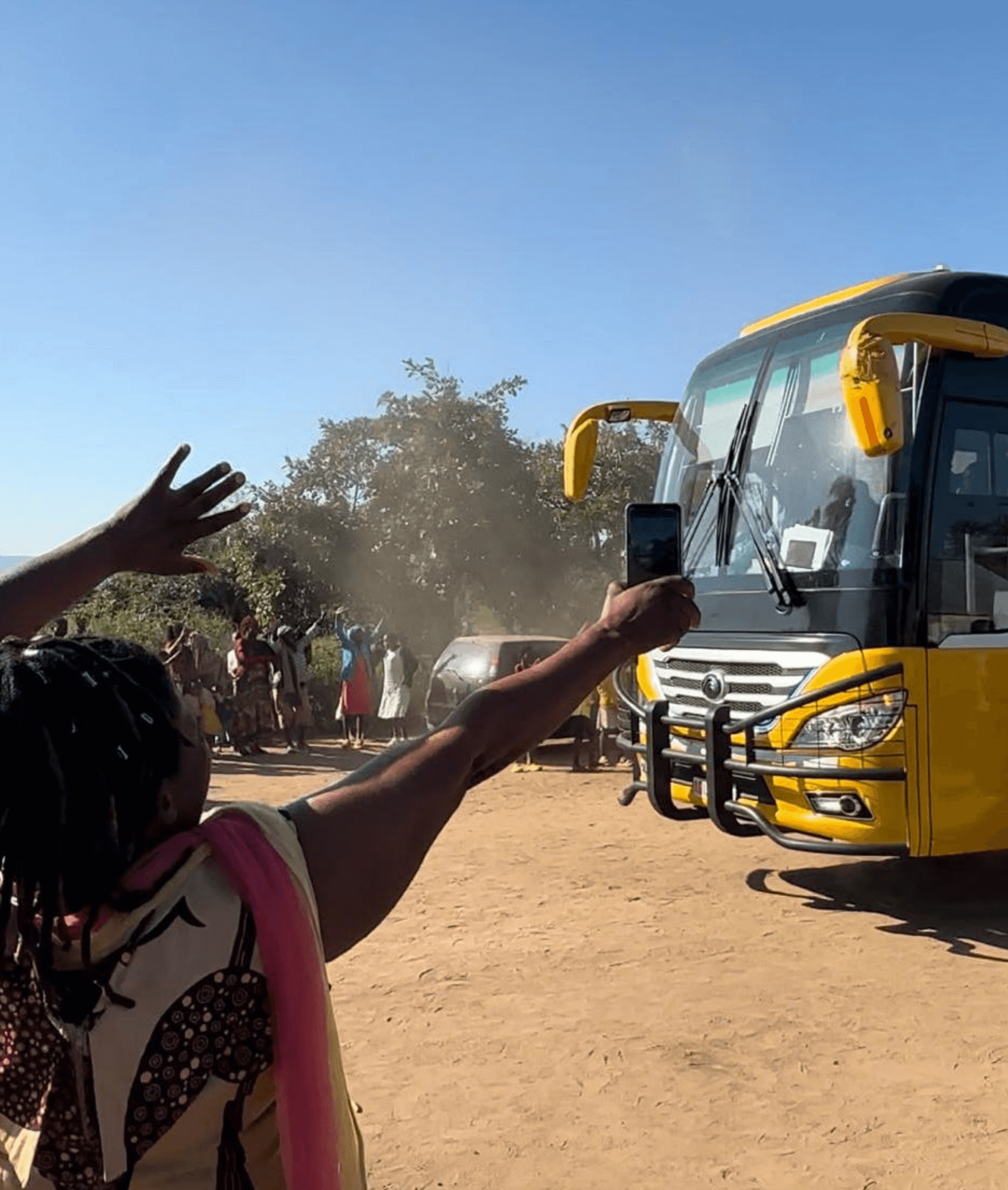 woman waving to a bus