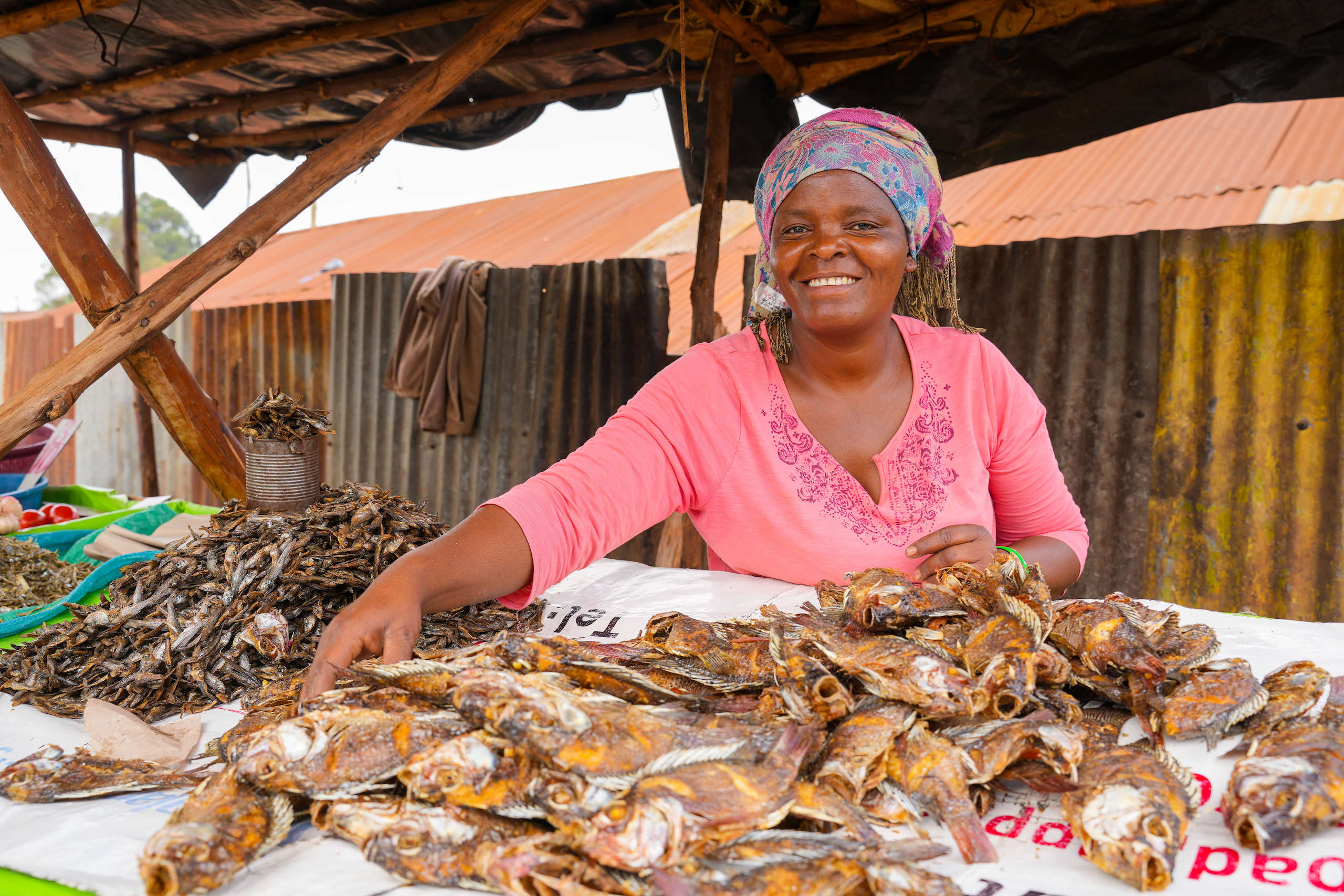 woman selling fish at a marketplace