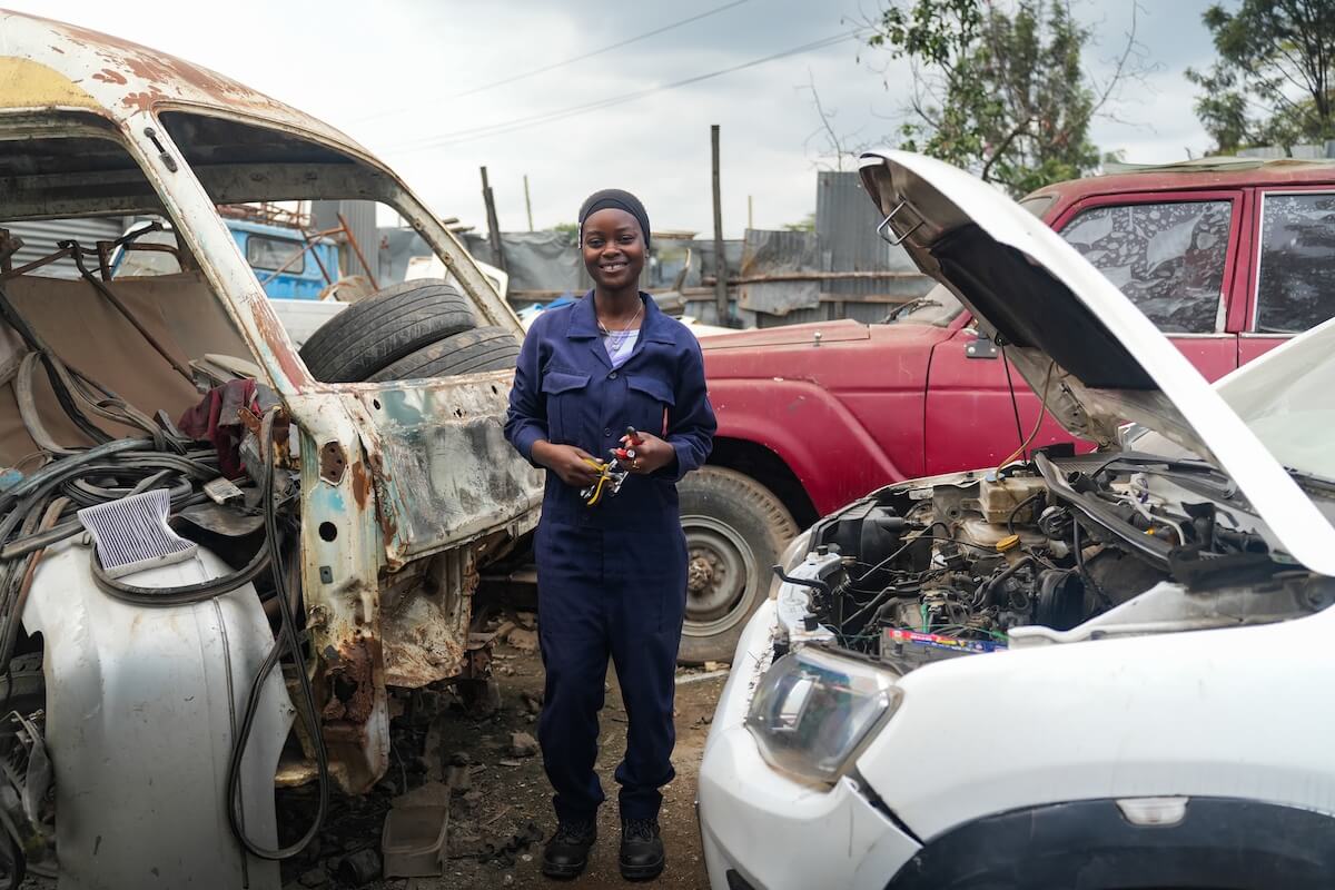 Ugwa stands around cars